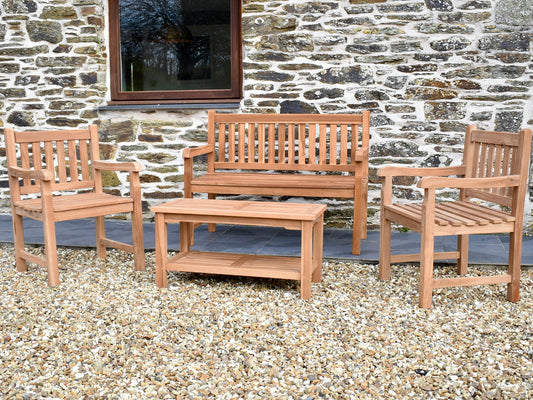 Four seater classic teak garden set comprising; 4ft/120cm classic teak garden bench, 2 classic teak garden armchairs and a 90x45cm rectangular teak garden coffee table with a shelf