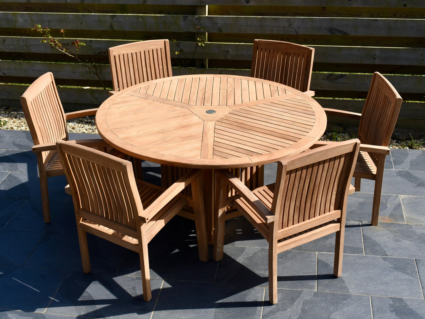 6 seater teak garden dining set comprising 150cm round radar design table with 6 Henley style stacking armchairs