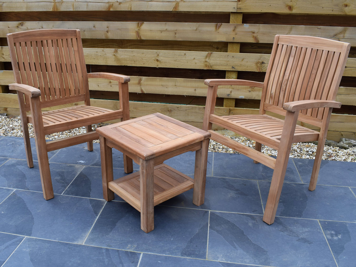 Small teak garden coffee table set with Henley style stacking garden armchairs, perfect for small outdoor spaces.