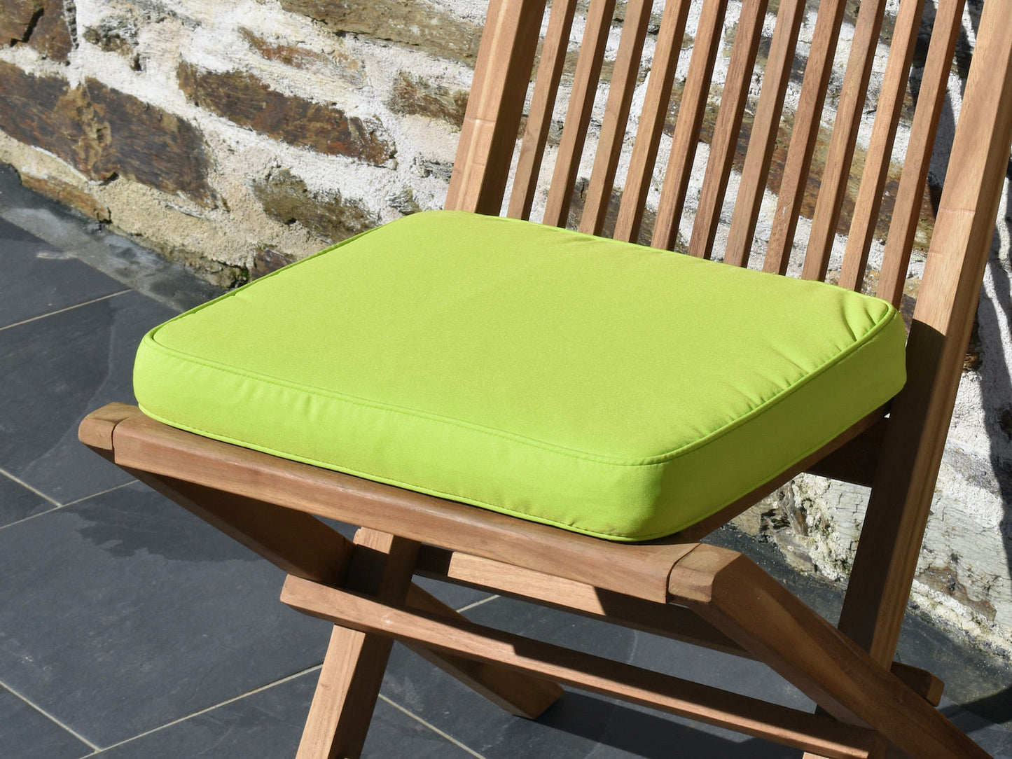 close-up fabric detail of light green small garden seat pad cushion