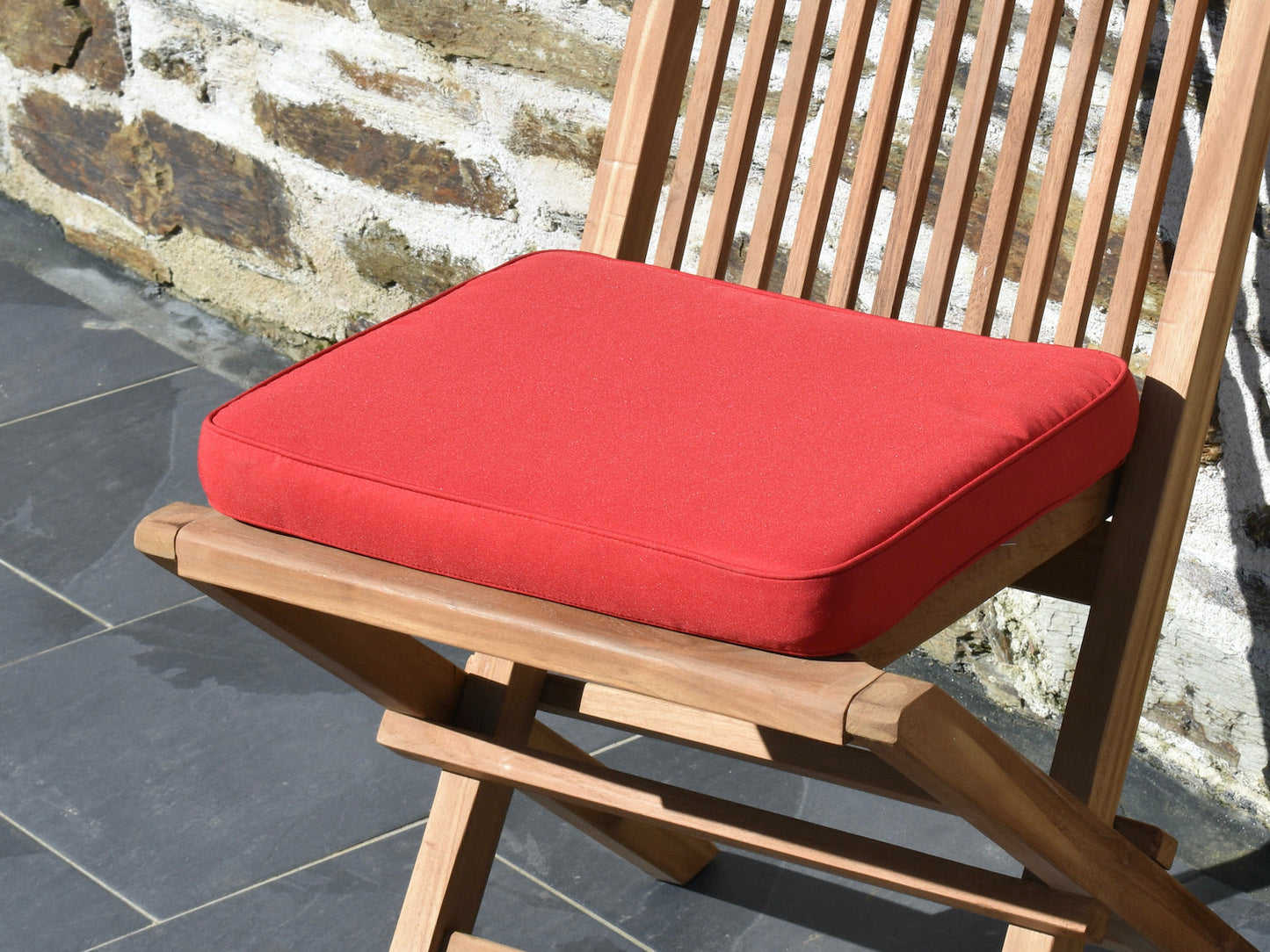 close-up polyester fabric of classic red small garden seat pad cushion