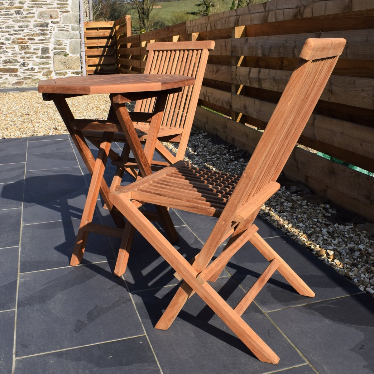 side view of a two seater teak folding garden dining set including 60cm octagonal folding table and 2 x classic teak folding dining chairs