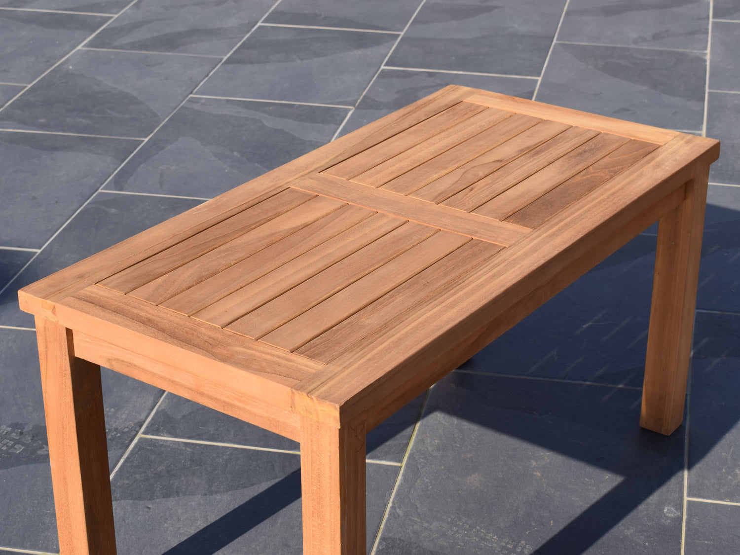 image shows detail of teak outdoor coffee table top 90x45cm rectangular