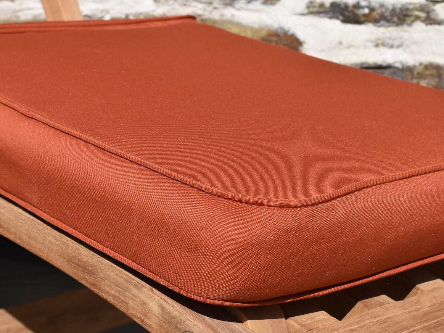 fabric detail close up of terracotta colour garden steamer chair cushion
