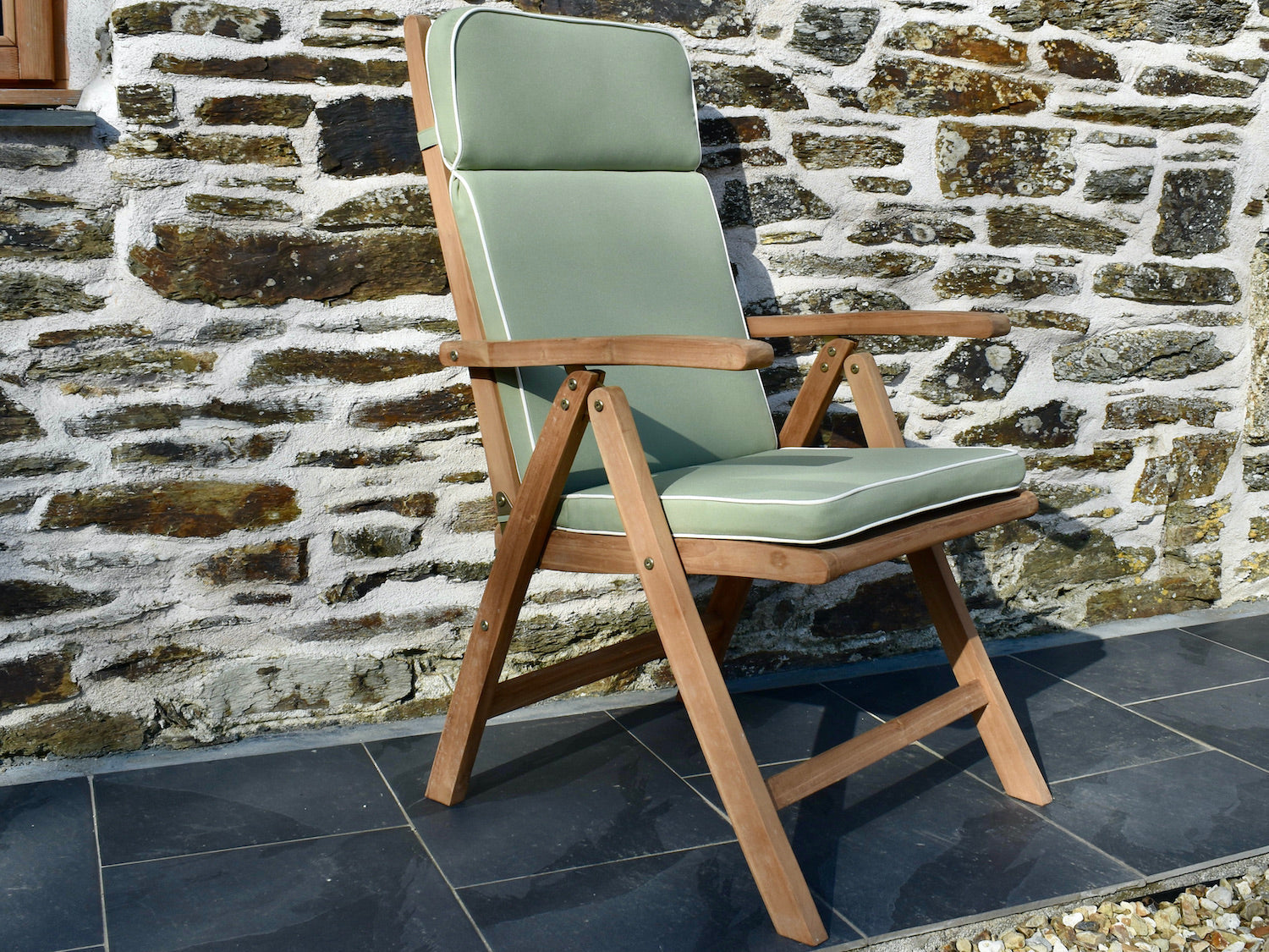 Light olive green colour outdoor cushion for a garden recliner chair with contrast white piping