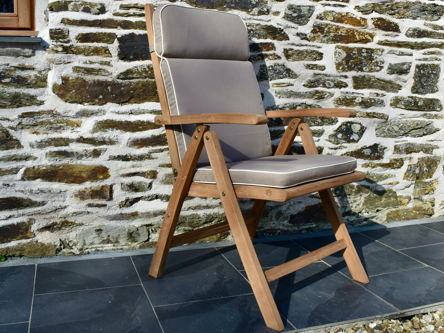 Taupe colour outdoor cushion for a garden recliner chair with contrast white piping