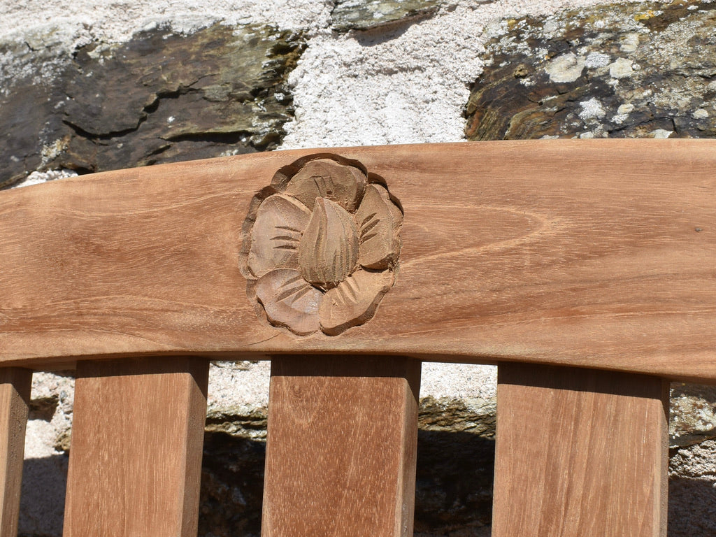 close-up detail of engraved rose motif on 6ft/4seater teak traditional garden bench