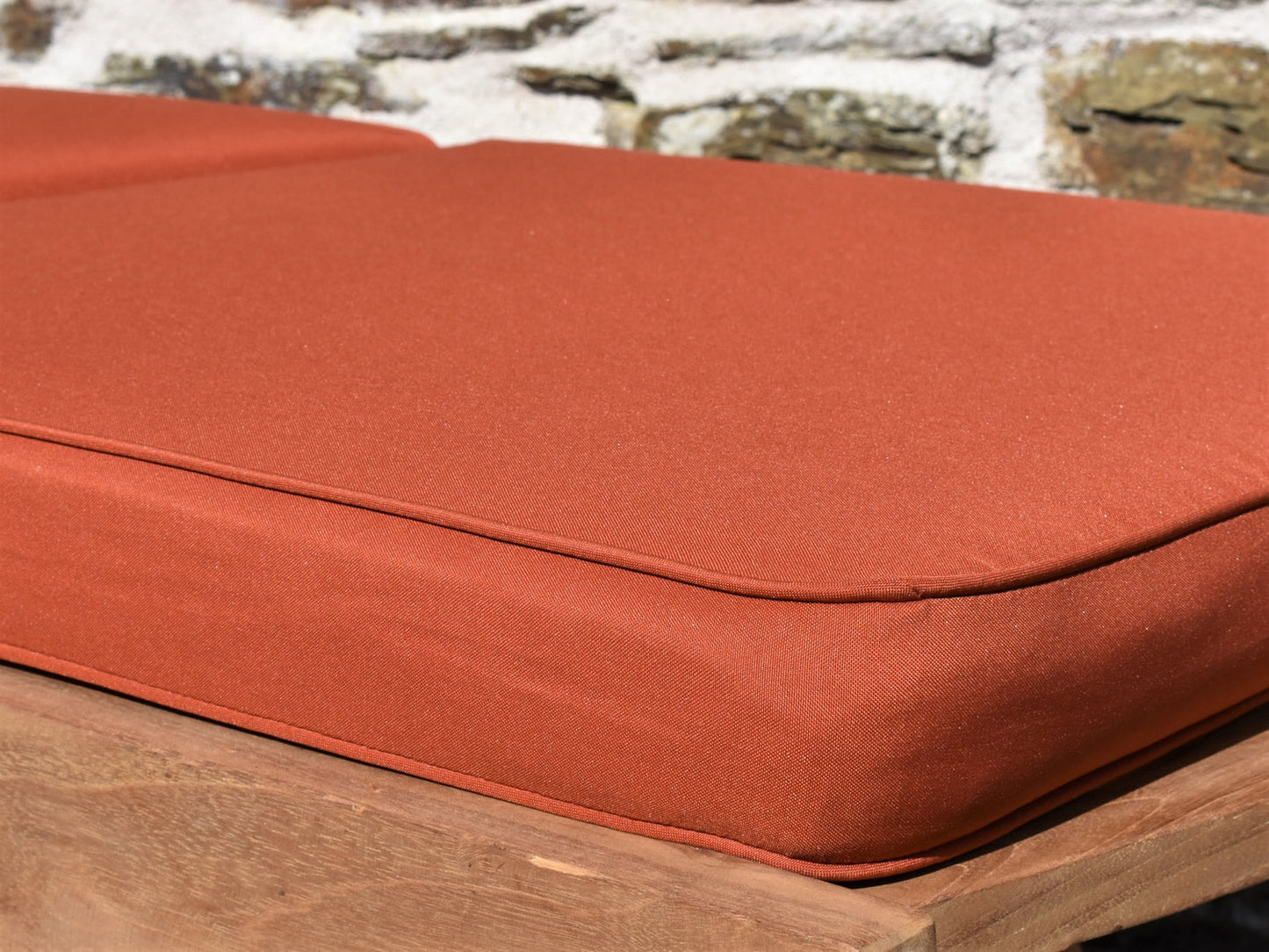 close-up detail of orange terracotta colour garden sunlounger cushion fabric