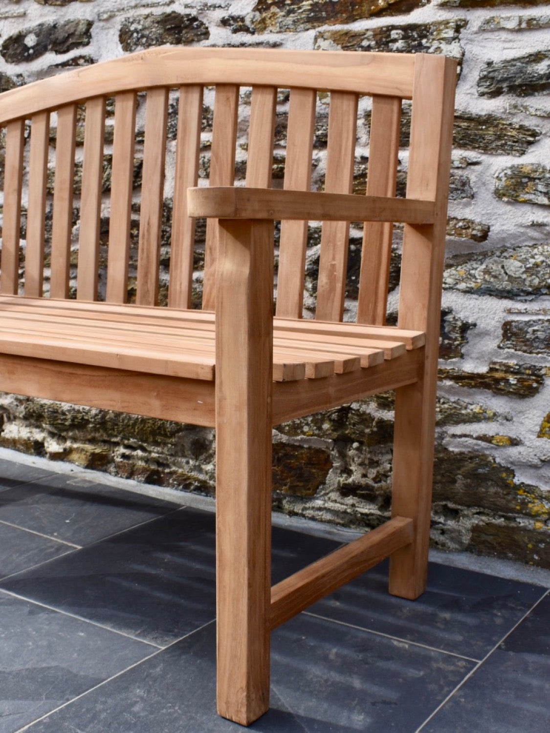 Close-up detail of teak curved garden bench