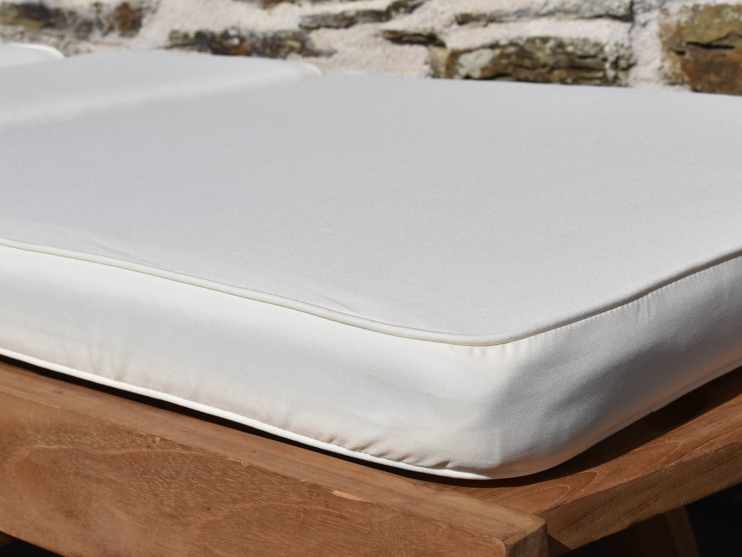 close up fabric detail of natural ecru colour garden sunlounger cushion